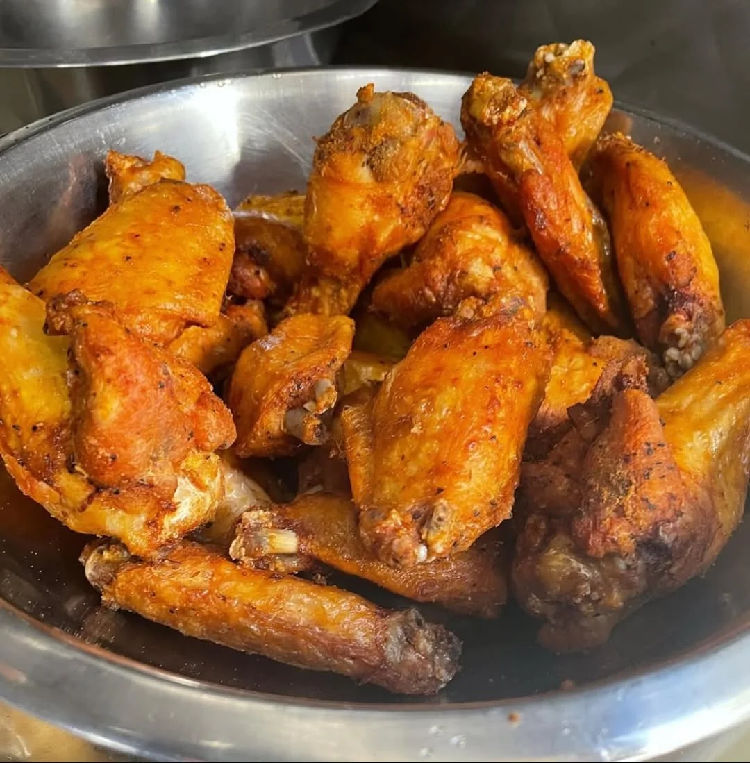 A bowl of glazed Dirty Birds chicken wings